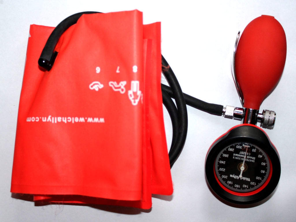 An aneroid blood pressure gauge with a red inflation bulb and a red adult arm cuff