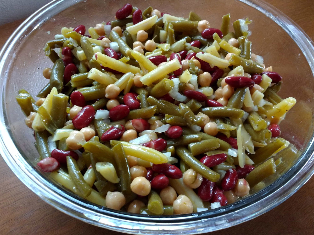 A bowl of bean salad with green beans, kidney beans, and chickpeas