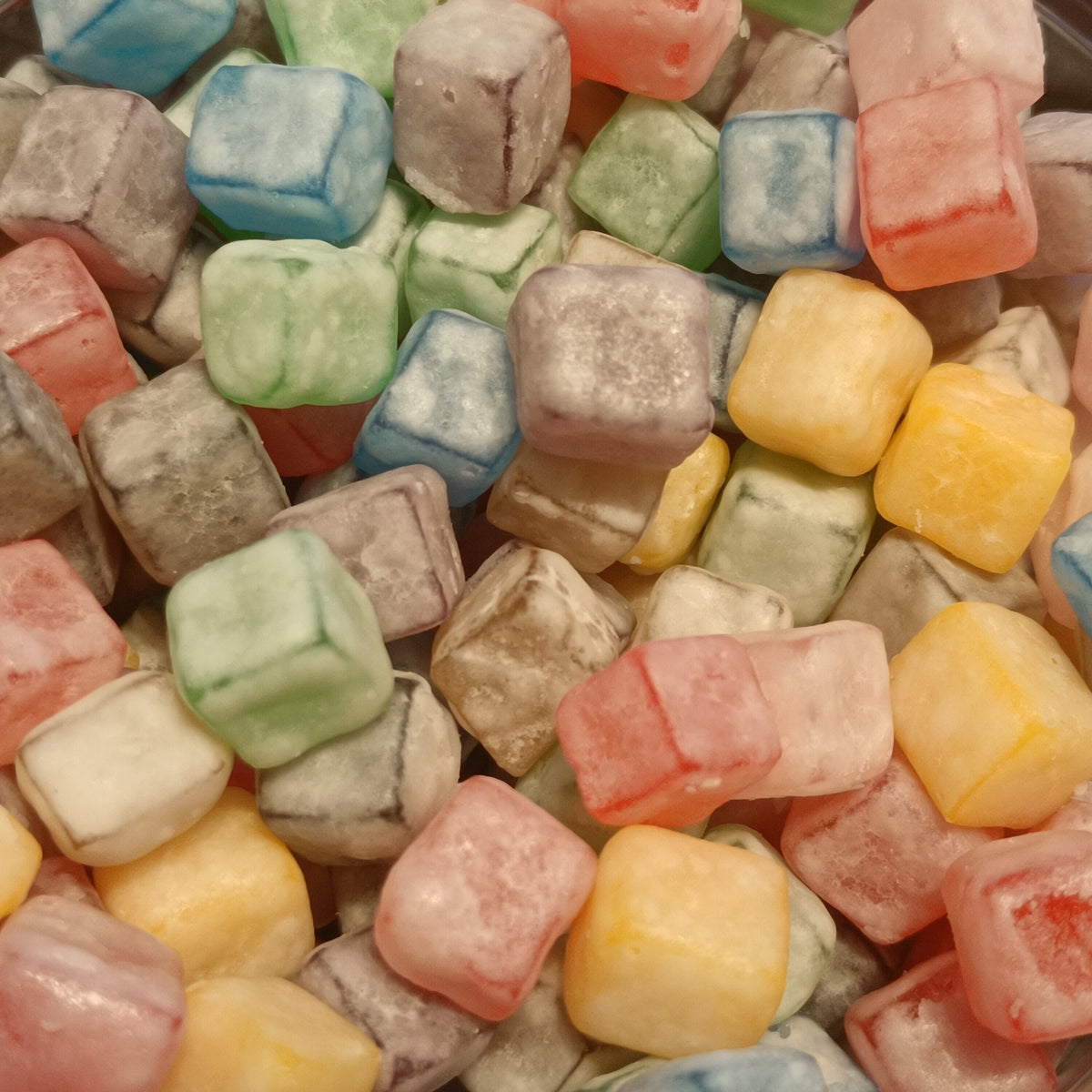Colorful cube-shaped gummy candies, the chewy format creatine gummies are made in