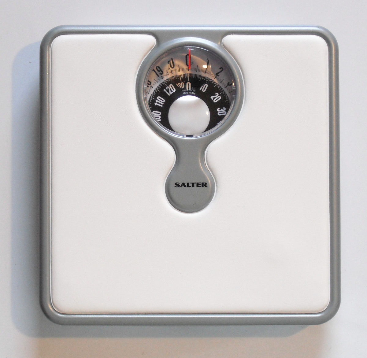 A bathroom scale on the floor, where creatine weight gain first shows up as a pound or two of water