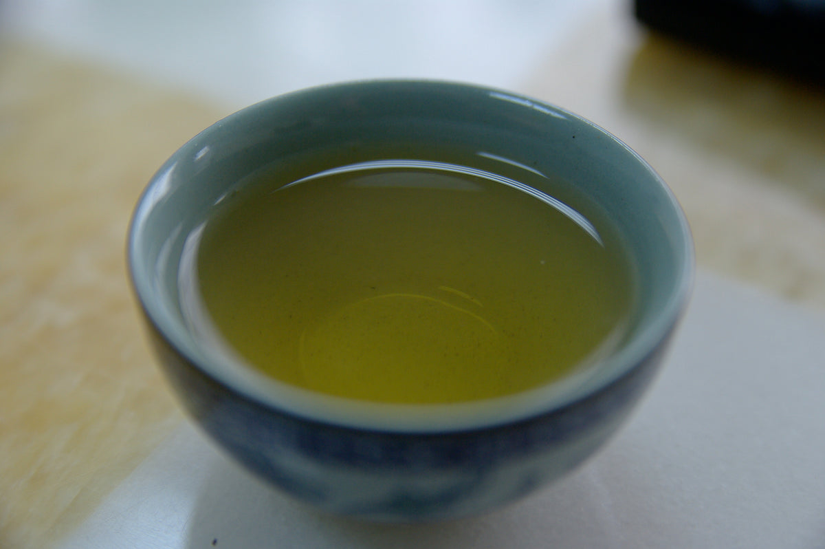A small cup of green tea, the source of the catechins found in many metabolism boosters for women
