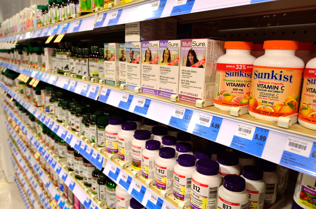 A pile of vitamin and supplement pills in different colors and shapes
